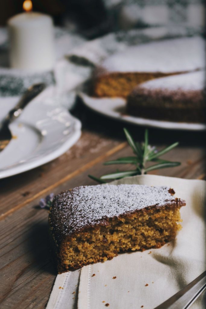 slice of chocolate spice cake with dusting of confectionery sugar